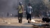 People carry weapons during riots in Meikhtila, Burma, Mar. 22, 2013. 
