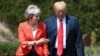 British Prime Minister Theresa May walks with President Donald Trump prior to a joint press conference at Chequers, in Buckinghamshire, England, July 13, 2018.