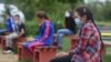 Students attend a class at an elementary school in Kacuni in an open-air classroom, before the start of the school year amid the coronavirus disease (COVID-19) outbreak, in Kacuni, Bosnia and Herzegovina, September 8, 2020. REUTERS/Dado Ruvic