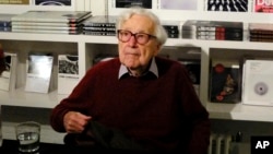 FILE - Former Life Magazine, New York Times and Washington Post picture editor John Morris during an interview in New York City, Oct. 14, 2014.