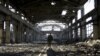 FILE - A Ukrainian serviceman walks through the rubble of a destroyed workshop after fighting with pro-Russian separatists in Avdiivka, Donetsk region, eastern Ukraine, March 31, 2017. 