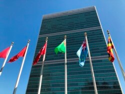FILE - Flags fly outside the United Nations headquarters in New York.