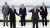 France's President Emmanuel Macron, U.S. President Joe Biden, European Commission President Ursula von der Leyen and Italy's Prime Minister Mario Draghi walk along the boardwalk during the G7 summit in Carbis Bay, Cornwall, Britain, June 11, 2021.