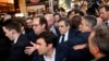 Conservative presidential candidate Francois Fillon, center right, makes his way while visiting the Agriculture Fair in Paris, March 1, 2017. Fillon is refusing to quit the race despite receiving a summons Wednesday to face charges for alleged fake parliamentary jobs for his family. 