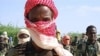 Recently trained Shebab fighters stand during military exercise in northern Mogadishu’s Suqaholaha neighborhood (Jan 2010 file photo)