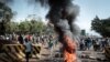 Opposition supporters block streets and burn tires during a protest in Kisumu, Kenya, on Oct. 11, 2017. Supporters of Kenya's opposition leader Raila Odinga took to the streets as poll officials mull their next move after his withdrawal from an upcoming presidential election.