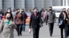 Pedestrians wear face masks to help prevent the spread of the coronavirus, Wednesday, April 1, 2020, in Pyongyang, North Korea. 