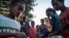 FILE - Displaced children from Western Tigray wait to receive food outside a classroom in the school where they are sheltering in Tigray's capital, Mekele, Feb. 24, 2021. Hunger and sexual violence have continued to rise dramatically since then.