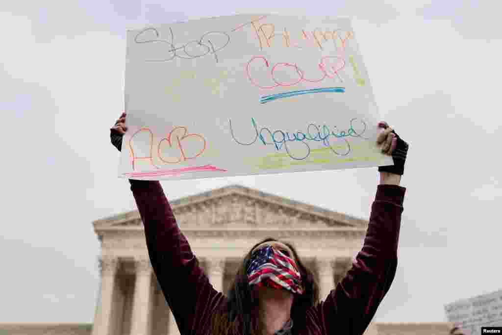 Una activista que se opone a la nominaci&#243;n de Amy Coney Barrett a la Corte Suprema sostiene un cartel que dice &quot;Detengan el Golpe de Trump&quot; en la Corte Suprema en Washington, D.C., el lunes 26 de octubre de 2020.