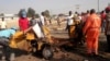 FILE - People clear debris after an explosion in Maiduguri, Nigeria, Oct. 29, 2016. Twin explosions from female suicide bombers suspected to be with Boko Haram killed nine people and injured more than 20 in Maiduguri.
