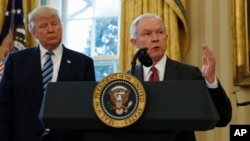 President Donald Trump listens as Attorney General Jeff Sessions speaks in the Oval Office of the White House in Washington, after Vice President Mike Pence administered the oath of office to Sessions. 