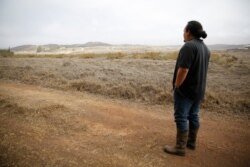 Kumu Micah Kamohoalii looks out at smoke from a wildfire near Waimea, Hawaii, Aug. 4, 2021.