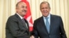 Russian Foreign Minister Sergey Lavrov, right, and his Turkish counterpart Mevlut Cavusoglu shake hands during their meeting in Moscow, Russia, Aug. 24, 2018. 