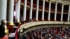 FILE - Visitors, top, and parliament members attend the questions to the government session at the National Assembly in Paris, Dec. 4, 2018