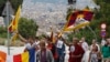 Buddhist monk Thubten Wangchen (3rd R) and participants walk with Tibetan flags and images of Mahatma Gandhi during their march for "peace and non-violence" from Plaza d'Espanya [Spain Circus] to the Montjuich castle in Barcelona October 2, 2010.