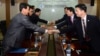 In this photo released by Unification Ministry, South Korean delegates, right, shake hands with their North Korean counterparts at Kaesong Industrial District Management Committee meeting, Kaesong, North Korea, Sept. 11, 2013.