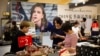 Shoppers browse at a mall in Beijing, Aug. 2, 2019. President Donald Trump intensified pressure on China to reach a trade deal by saying he will impose 10% tariffs Sept. 1 on the remaining $300 billion in Chinese imports he hasn't already taxed.