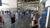 Voters wait in line to cast their ballots in the Kentucky primary at Kroger Field in Lexington, Kentucky, June 23, 2020.