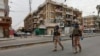 FILE - Iraqi security forces are seen on patrol in central Baghdad, Iraq, April 7, 2020. 