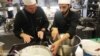 Chef of the Hotel d’Angleterre, Michael Coquelle, left, and Chef Nadeem Khadem al-Jamie, who is also a Syrian refugee, work together in the hotel's kitchen for the Refugee Food Festival, Oct. 11, 2017.