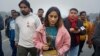 Indian wrestler Vinesh Phogat, a two-time World Championship medal winner, walks with her national sports awards before leaving them on a pavement near the prime minister's office as a mark of protest in New Delhi, India, Dec. 30, 2023.