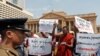 FILE - Protesters in Sri Lanka denounce the government's decision to issue death certificates for persons gone missing during country's civil war, in Colombo, Feb. 11, 2020. The placards read "Who killed the disappeared?" in Tamil and Sinhalese.