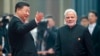 Chinese President Xi Jinping, left, welcomes Indian Prime Minister Narendra Modi for a meeting at the Shanghai Cooperation Organization (SCO) Summit in Qingdao in eastern China's Shandong Province, June 10, 2018. 
