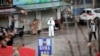 A worker in a protective suit is seen at the closed seafood market in Wuhan, Hubei province, China January 10, 2020. REUTERS/Stringer