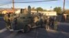 Law enforcement officers with armored vehicles search an area near Wednesday's shooting attack in San Bernardino, California, Dec. 3, 2015. 