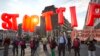 Protesters hold an anti-TTIP inflatable banner during a demonstration against international trade agreements in Brussels, Sept. 20, 2016.