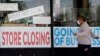 A man looks at signs of a closed store due to COVID-19 in Niles, Ill, May 21, 2020. U.S. businesses shed 2.76 million jobs in May, as the economic damage from the historically unrivaled coronavirus outbreak stretched into a third month.