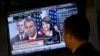 FILE - Specialist Frank Masiello watches a television monitor on the floor of the New York Stock Exchange showing a Washington news conference by House Speaker John Boehner, Tuesday, Oct. 15, 2013. 