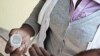 Nolitha Tsilana, a MSF nurse, delivers TB pills to a patient at Lizo Nobanda TB Care Centre in Khayelitsha township, Cape Town. 
