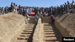 FILE - Graves are prepared for the burial of civilians killed by insurgents at Mirza Olang village, in Sar-e Pul province, Afghanistan, Aug. 16, 2017.