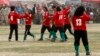 FILE - The Afghan national women's soccer team celebrates a victory in a friendly match against a women's team from the NATO-led International Security Assistance Force in Kabul, Oct. 29, 2010.