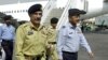 FILE - Lt. General Shahid Aziz (foreground, left) walks with military officials at Allama Iqbal International Airport in Lahore, Pakistan, March 25, 2004.