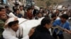 People carry the body of a woman they recovered from under the rubble of a house destroyed by a Saudi-led airstrike in Sanaa, Yemen, Aug. 25, 2017. 