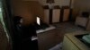 FILE - A man uses a computer at an internet cafe in Rawalpindi, Pakistan, Sept. 18, 2013