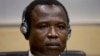 Dominic Ongwen, a Ugandan commander in warlord Joseph Kony's feared militia, waits for the judge to arrive as he made his first appearance at the International Criminal Court in The Hague, Netherlands, Jan. 26, 2015.