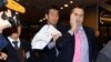 U.S. ambassador to South Korea Mark Lippert, right, covers a slash on his face as he leaves the Sejong Cultural Institute in Seoul, after he was attacked by an armed assailant, in Seoul, March 5, 2015.