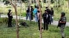 Security personnel investigate around bodies of insurgents at the site of an attack on an army base in the troubled southern province of Narathiwat, February 13, 2013. 