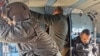 FILE - Iraqi security forces are seen in a helicopter during military operations to search for Islamic State militants in Anbar province, Iraq, Dec. 29, 2019.