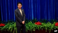 Japan's Prime Minister Shinzo Abe waits to meet China's President Xi Jinping, during their meeting at the Great Hall of the People, on the sidelines of the Asia Pacific Economic Cooperation meetings, in Beijing, Nov. 10, 2014.
