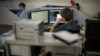 FILE - Employees of Moscow’s Group-IB, which is responsible for one of Russia’s two official internet watchdogs, work in their laboratory in Moscow, Russia, May 30, 2013.