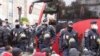 Migrants wait to board a bus in Paris, France, November 2016. (L. Bryant/VOA)