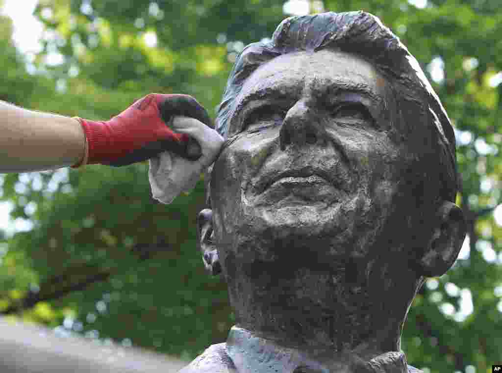 Cleaner Adam Gawronski polishes the bronze monument of former U.S. President Ronald Reagan in downtown Warsaw, Poland ahead of the NATO summit to be held in Warsaw in July, to be attended by President Barack Obama, and ahead of the June 5 anniversary of Reagan&#39;s death.