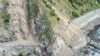 FILE - Landslides block State Highway One near Kaikoura on the upper east coast of New Zealand's South Island following an earthquake, Nov. 14, 2016.