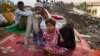 Rohingya man Nur Ahmad, 70, his wife Lalu Bibi and their grand daughter Ashuka Bibi, 5, who crossed over to Bangladesh the previous day, wait for permission to go to the refugee camps after spending the night in the rice fields near Palong Khali, Bangladesh, Nov. 2 2017. It took them nine days to reach the border since they left their family home at Buthi Dawng district. 