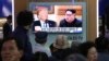 People watch a TV screen showing file footage of U.S. President Donald Trump, left, and North Korean leader Kim Jong Un during a news program at the Seoul Railway Station in Seoul, South Korea, May 16, 2018.