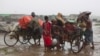 Internally displaced Rohingya people load rickshaws with children and belongings to leave their camp in Sittwe, northwestern Rakhine State, Burma, May 16, 2013.